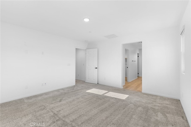 unfurnished room with light carpet