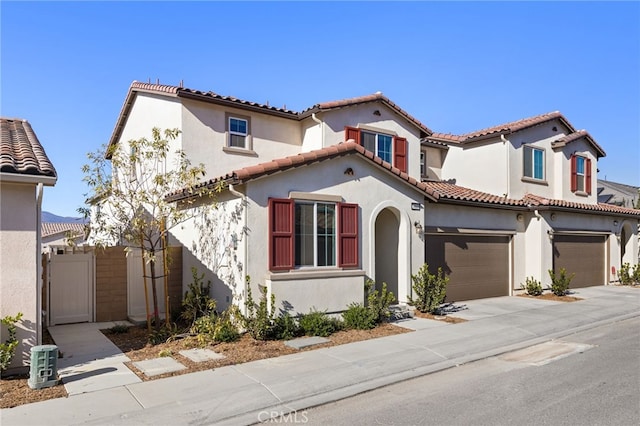 mediterranean / spanish-style house with a garage