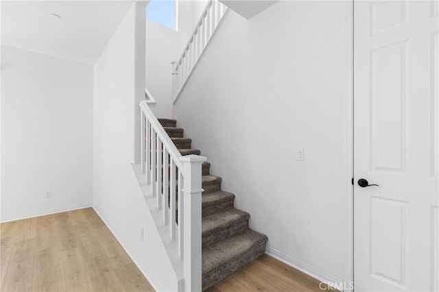 stairs featuring wood-type flooring