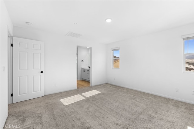 unfurnished bedroom with light colored carpet