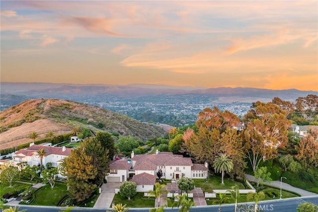 aerial view at dusk featuring a mountain view