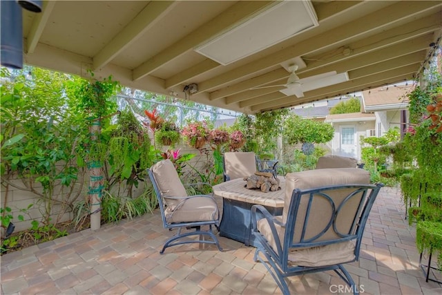 view of patio with an outdoor fire pit and ceiling fan