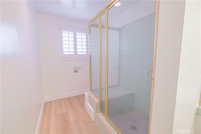 bathroom with hardwood / wood-style floors and walk in shower