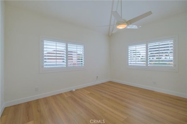 empty room featuring ceiling fan and light wood-type flooring