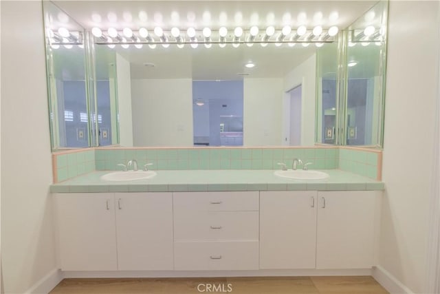 bathroom with backsplash and vanity