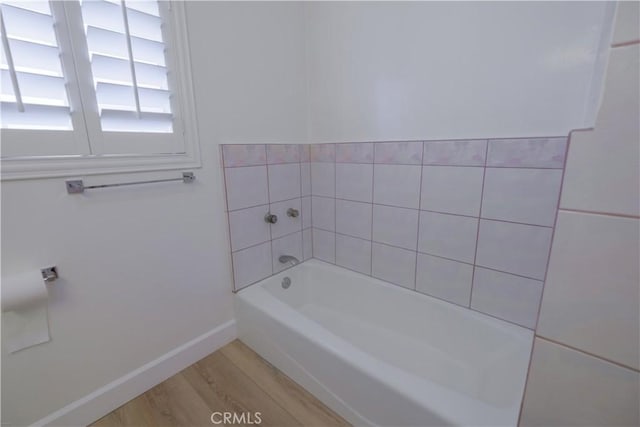 bathroom featuring hardwood / wood-style floors and a bath