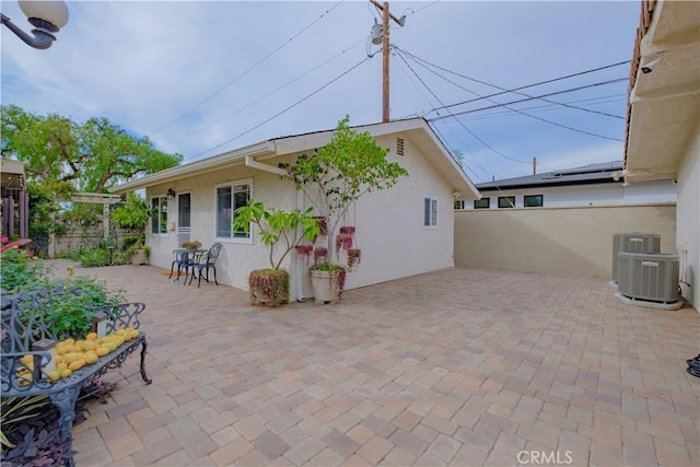 rear view of house featuring a patio area and central air condition unit