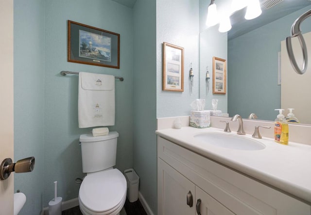 bathroom featuring toilet and vanity