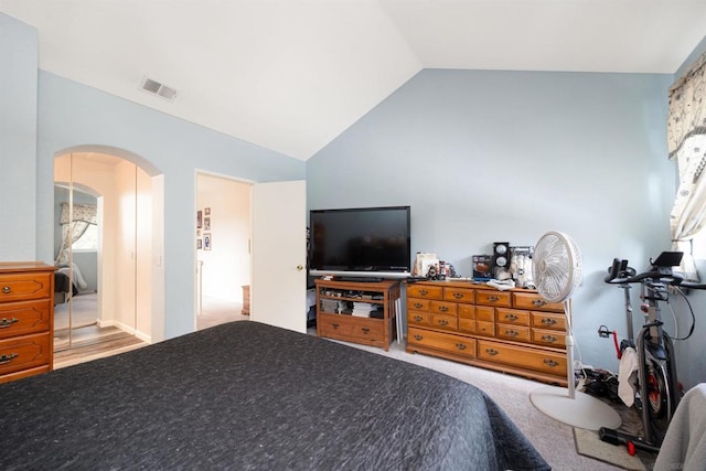 carpeted bedroom featuring vaulted ceiling