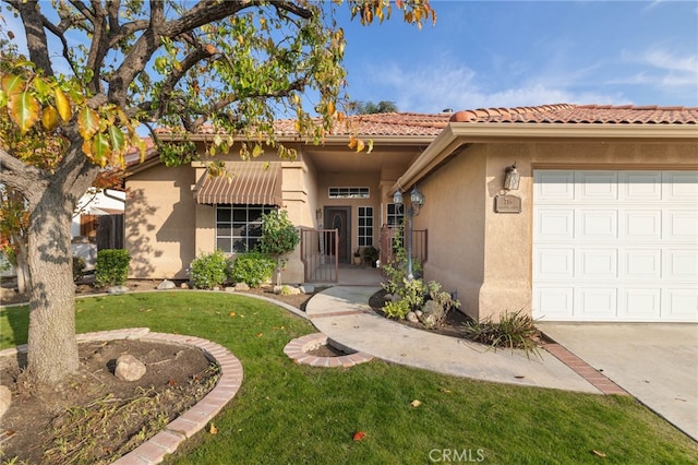 mediterranean / spanish-style home with a front lawn and a garage