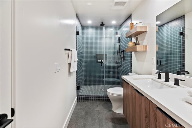 bathroom featuring vanity, toilet, and an enclosed shower