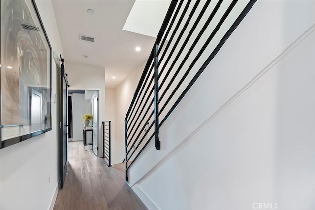 stairs featuring hardwood / wood-style floors