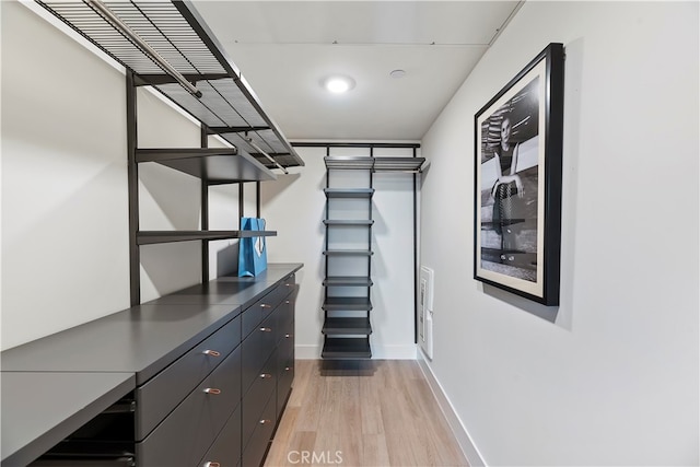 spacious closet featuring light hardwood / wood-style floors