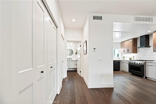 hallway with dark hardwood / wood-style flooring