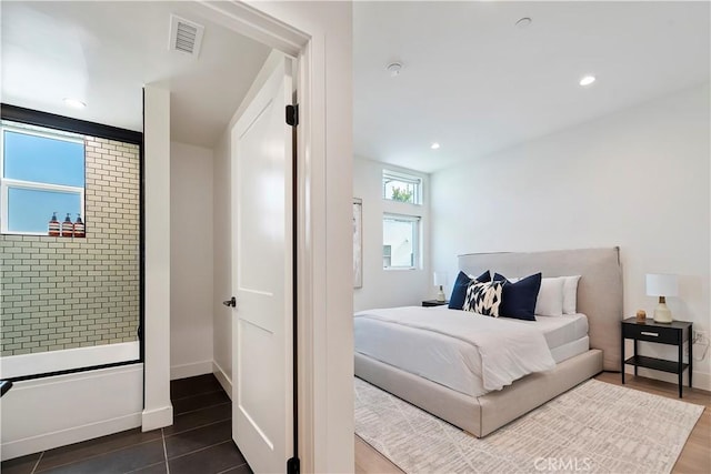 bedroom with dark tile patterned flooring