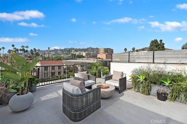 view of patio with an outdoor living space with a fire pit