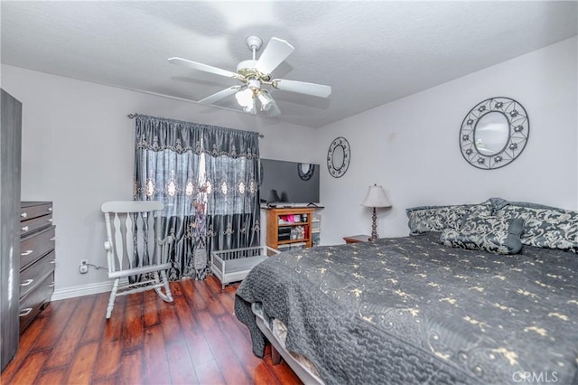 bedroom with ceiling fan and dark wood-type flooring