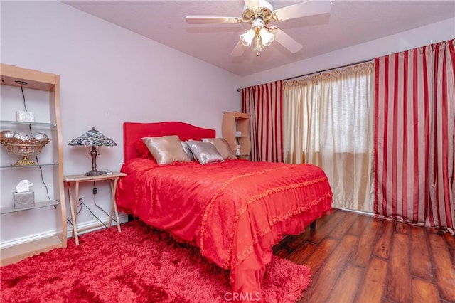 bedroom with dark hardwood / wood-style floors and ceiling fan