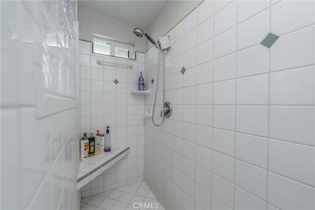 bathroom with a tile shower