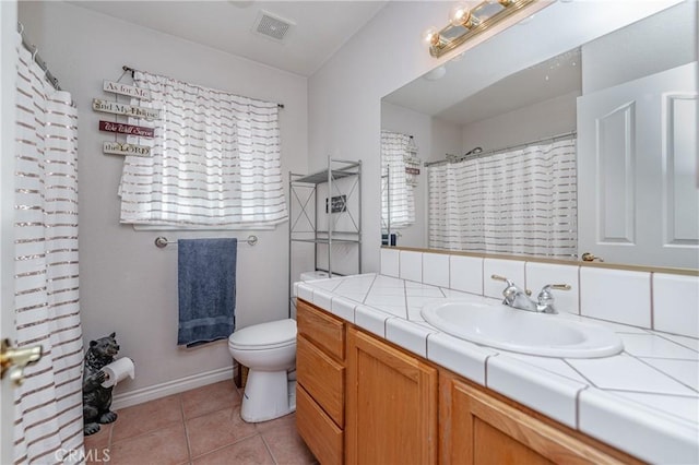 bathroom featuring tile patterned floors, vanity, and toilet