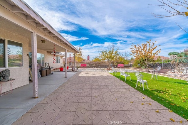 view of patio featuring ceiling fan