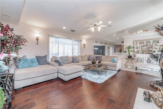 living room with wood-type flooring, vaulted ceiling, and ceiling fan