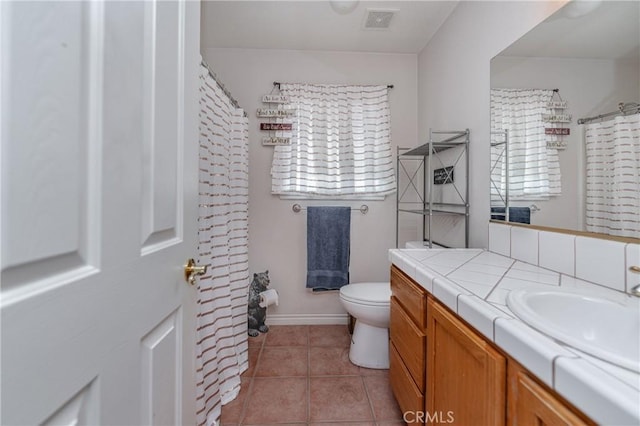 bathroom featuring tile patterned flooring, vanity, and toilet