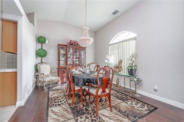 dining area with hardwood / wood-style flooring and lofted ceiling