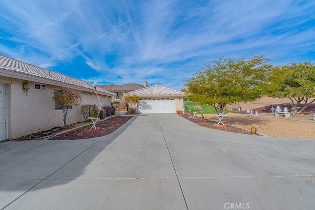 view of front of property featuring central AC and a garage