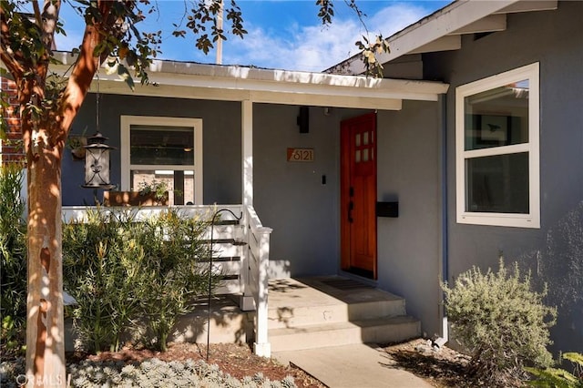 view of exterior entry with covered porch