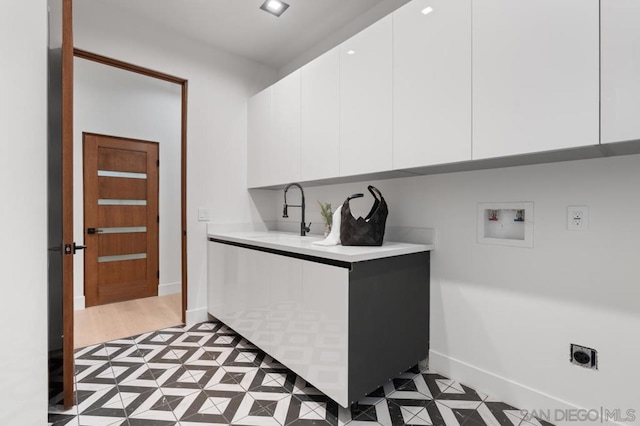 laundry area with electric dryer hookup, sink, cabinets, and washer hookup