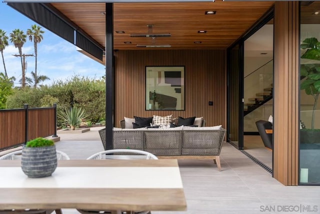 view of patio with an outdoor living space and ceiling fan