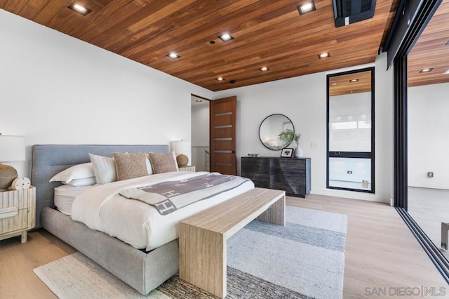 bedroom with light hardwood / wood-style floors and wood ceiling