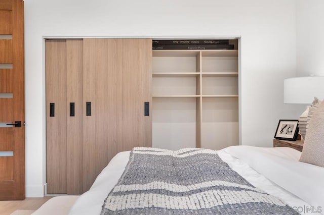 bedroom featuring light hardwood / wood-style flooring and a closet