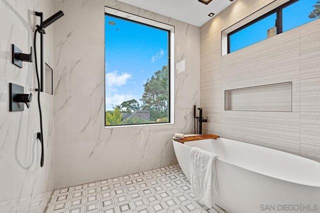 bathroom featuring tile patterned flooring and separate shower and tub