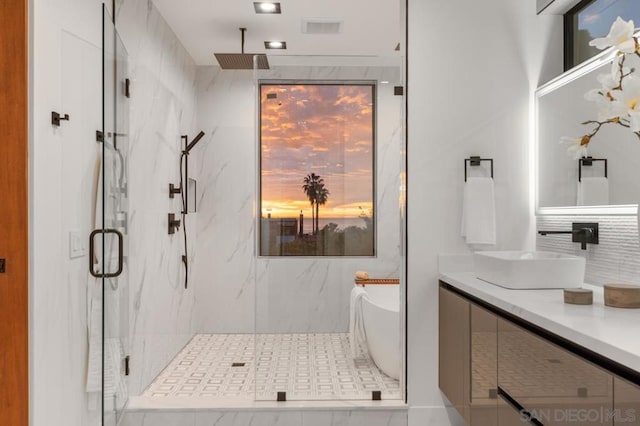 bathroom with separate shower and tub, plenty of natural light, and vanity