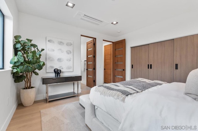 bedroom featuring a closet and light hardwood / wood-style floors