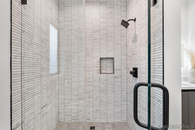 bathroom with a shower with door