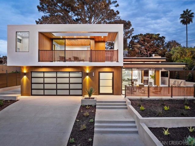 contemporary house featuring a balcony and a garage