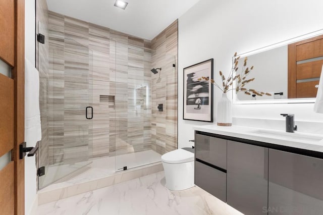 bathroom with vanity, toilet, and a shower with shower door