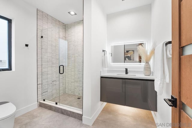 bathroom featuring tile patterned flooring, vanity, toilet, and a shower with shower door