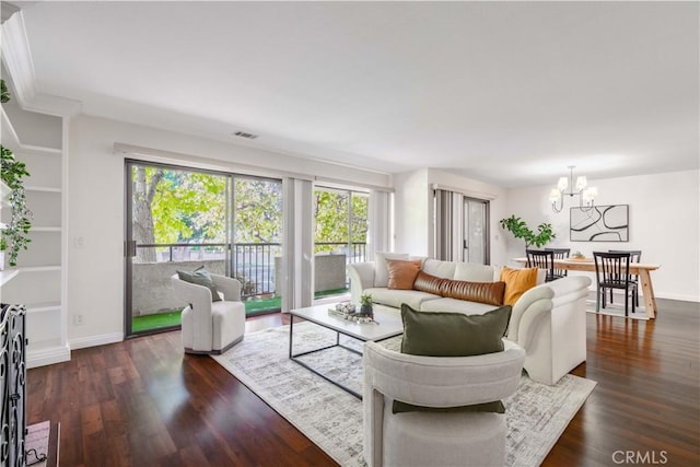 living room featuring plenty of natural light, dark wood-type flooring, and a chandelier