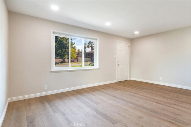 spare room featuring light hardwood / wood-style flooring