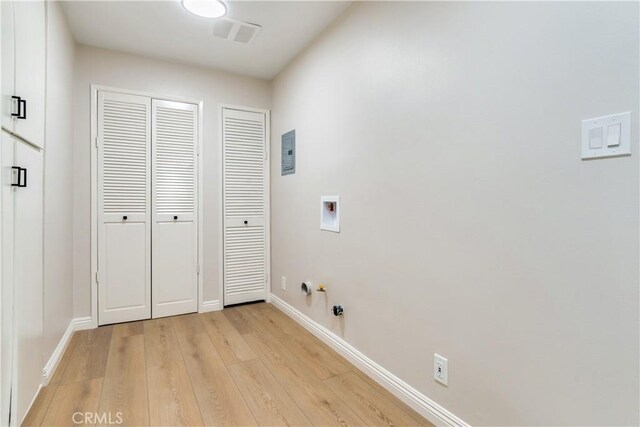 clothes washing area featuring gas dryer hookup, hookup for a washing machine, and light wood-type flooring