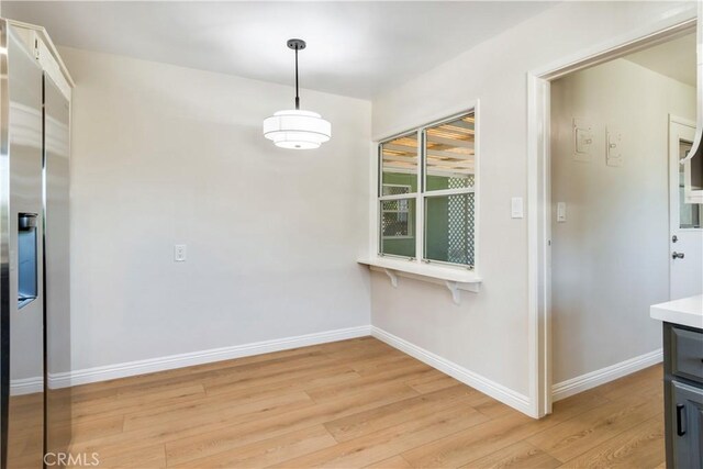 unfurnished dining area with light hardwood / wood-style flooring