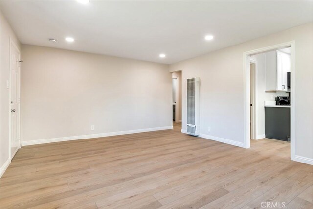 empty room with light hardwood / wood-style flooring