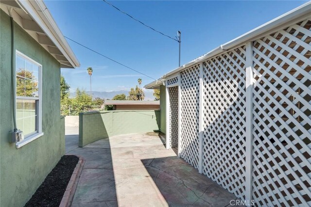 view of property exterior with a patio area