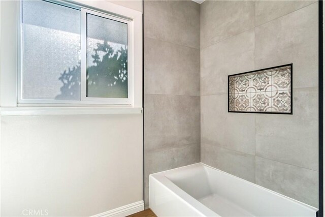 bathroom featuring washtub / shower combination