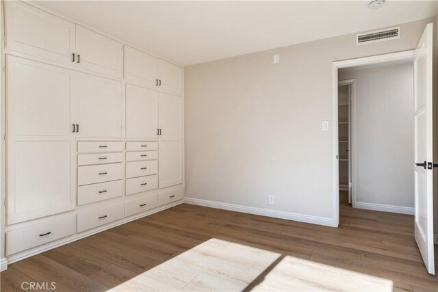 unfurnished bedroom with hardwood / wood-style floors