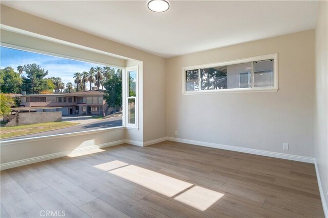 unfurnished room featuring light hardwood / wood-style flooring